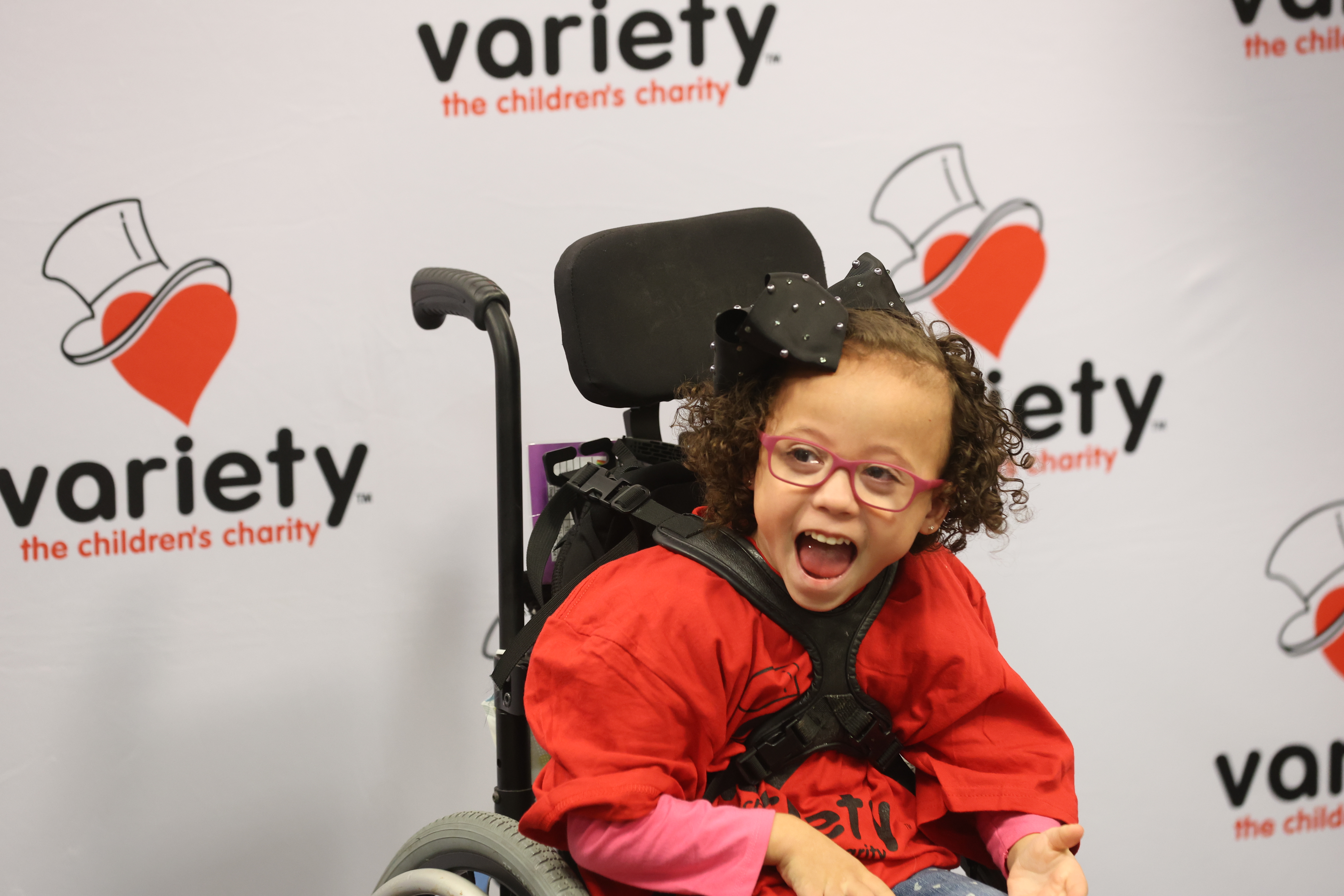 child in wheelchair smiling