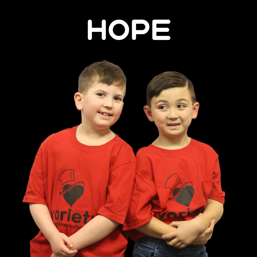 Two little boys smiling with the word HOPE