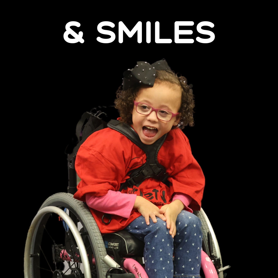 Little girl in a wheelchair with the word SMILES