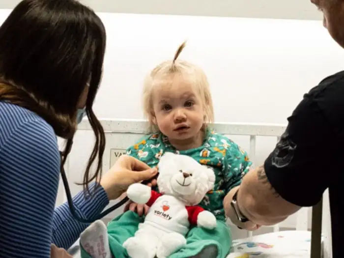 Child in hospital bed with Variety Bear